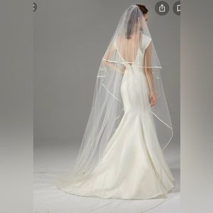 Peter Langner Oval shaped veil in tulle with blusher and silk magnolia trim.